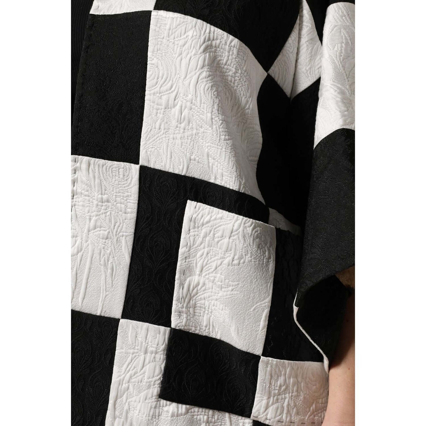 Close-up of Dolce & Gabbana black and white patchwork jacquard blazer jacket texture.