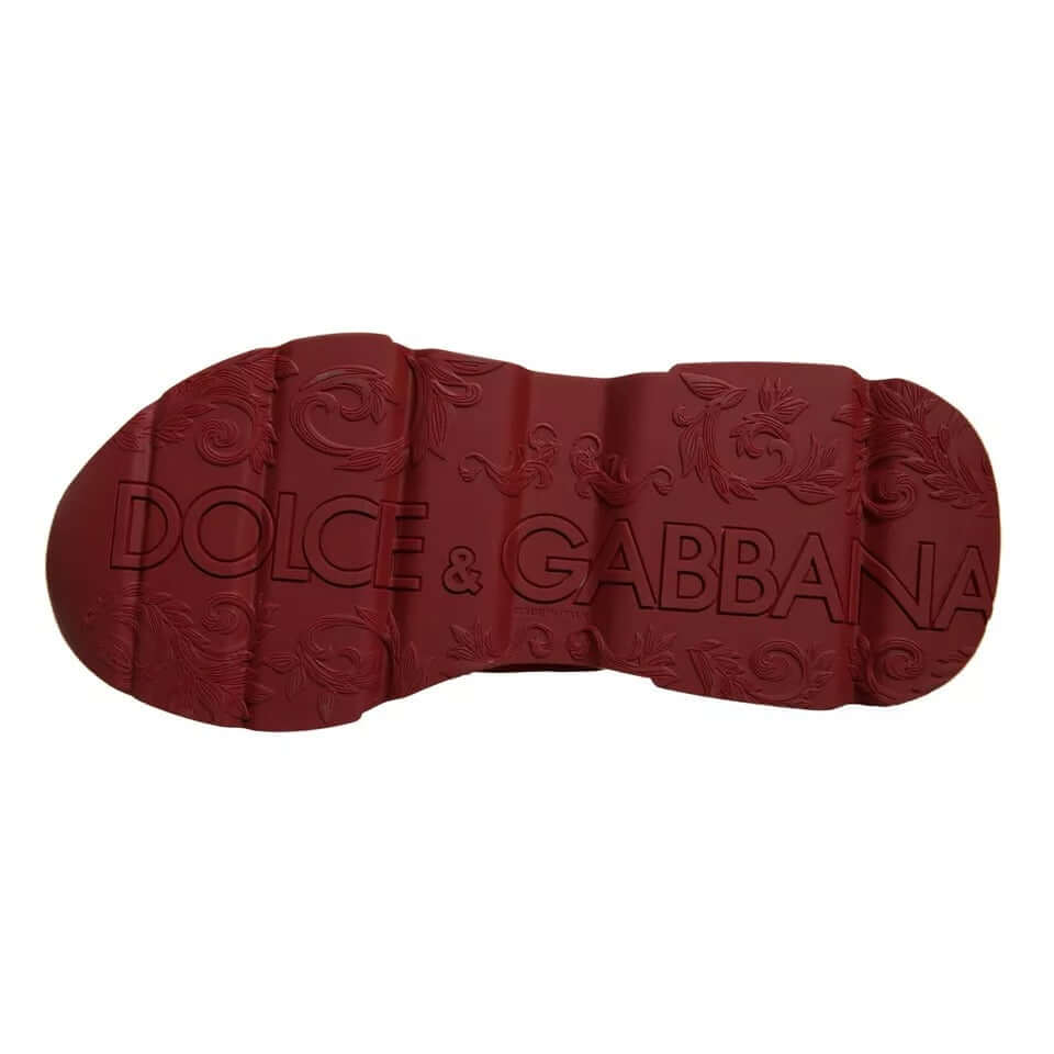 Dolce & Gabbana red leather Daymaster sneaker sole with intricate logo and design pattern, showcasing brand craftsmanship.