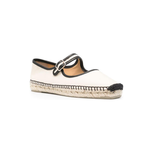Castaner white flat shoes with side buckle, square toe, and braided raffia sole. Light beige canvas espadrilles with black trim.