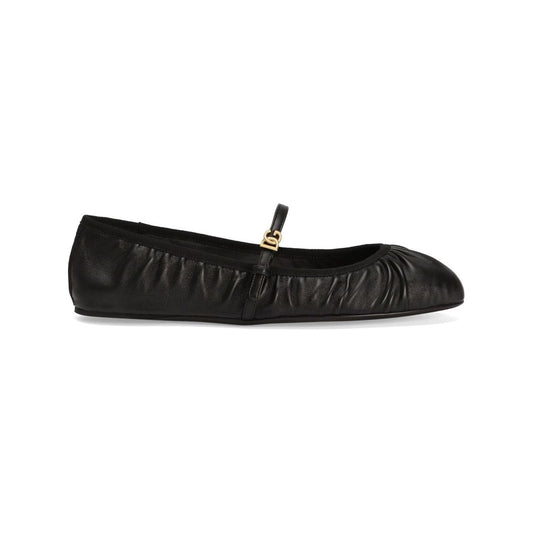 Black Nappa leather ballet flats by Dolce & Gabbana with side buckle, leather sole, and gold-tone logo plaque.
