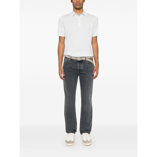 Model wearing Brunello Cucinelli T-shirts and Polos Clear Blue, featuring light blue cotton knit, front button placket, ribbed cuffs.