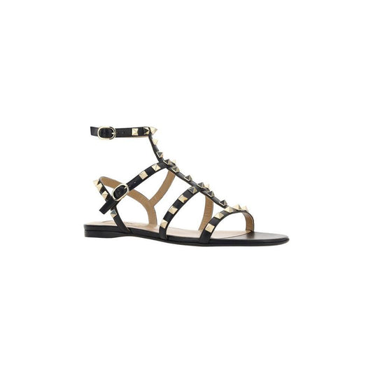 Valentino Garavani Rockstud Sandals with leather, round toe, ankle strap, flat sole, iconic studs, and branded insole.