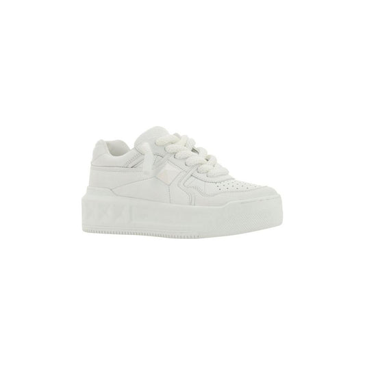 Valentino Garavani leather sneakers with lace-up closure, stud detail, and branded insole. Round toe and textured sole for stylish comfort.