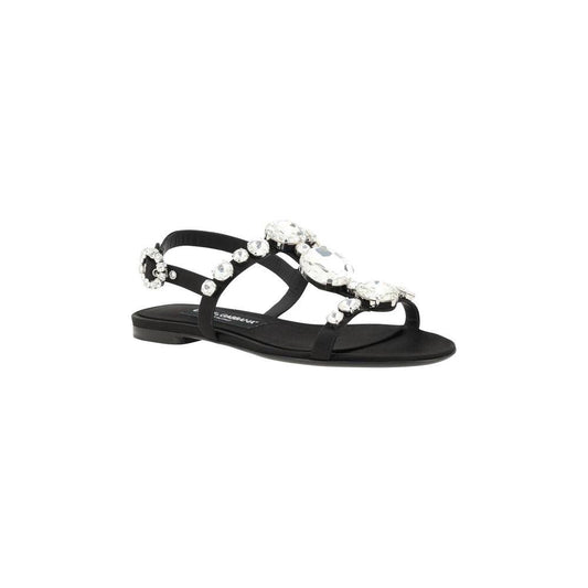 Dolce & Gabbana black jeweled sandals with caged design, almond toe, block heel, and jeweled buckle, offering both comfort and luxury.