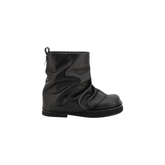 The Attico Mini Robin Ankle Boots in black leather, featuring a round toe, slight block heel, and iconic metal logo plaque on calf.