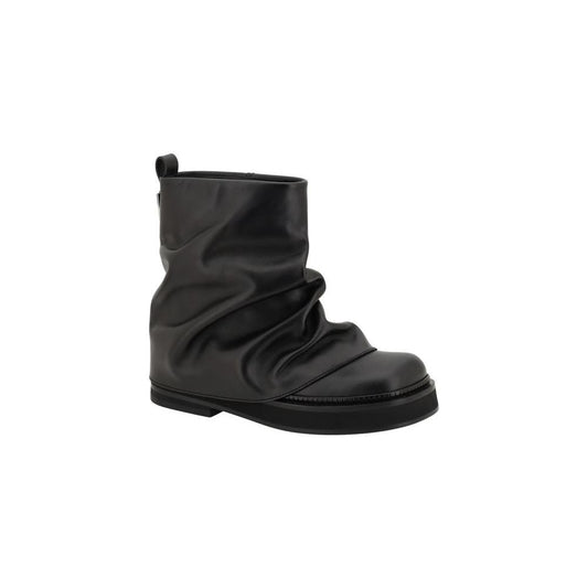 The Attico Mini Robin Ankle Boots in black leather with unique soft design, round toe, slight block heel, and metal logo plaque.