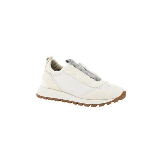 Brunello Cucinelli slip-on sneakers with knurled sole, suede details, round toe, and jewel-embellished band. Monogram on heel.