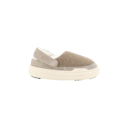 Moon Boot Mules with suede detailing, shearling interior, and non-slip sole. Features round toe and brand monogram slingback.