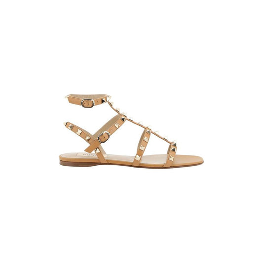 Valentino Garavani Rockstud Sandals, leather with iconic studs, round toe, adjustable ankle strap, flat sole, branded insole.