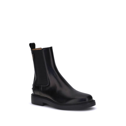 Tod's Black Calf Leather Bos Taurus Chelsea Boots with elastic sides and rubber sole, featuring Tod's logo and pebble details for comfort.