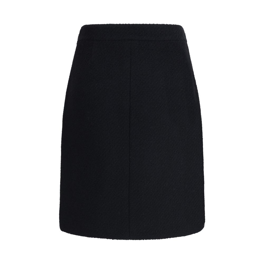 Chloé Black Wool Midi Skirt with front flap pockets, gold-tone buttons, crafted from premium bouclé wool, side zip and hook fastening.