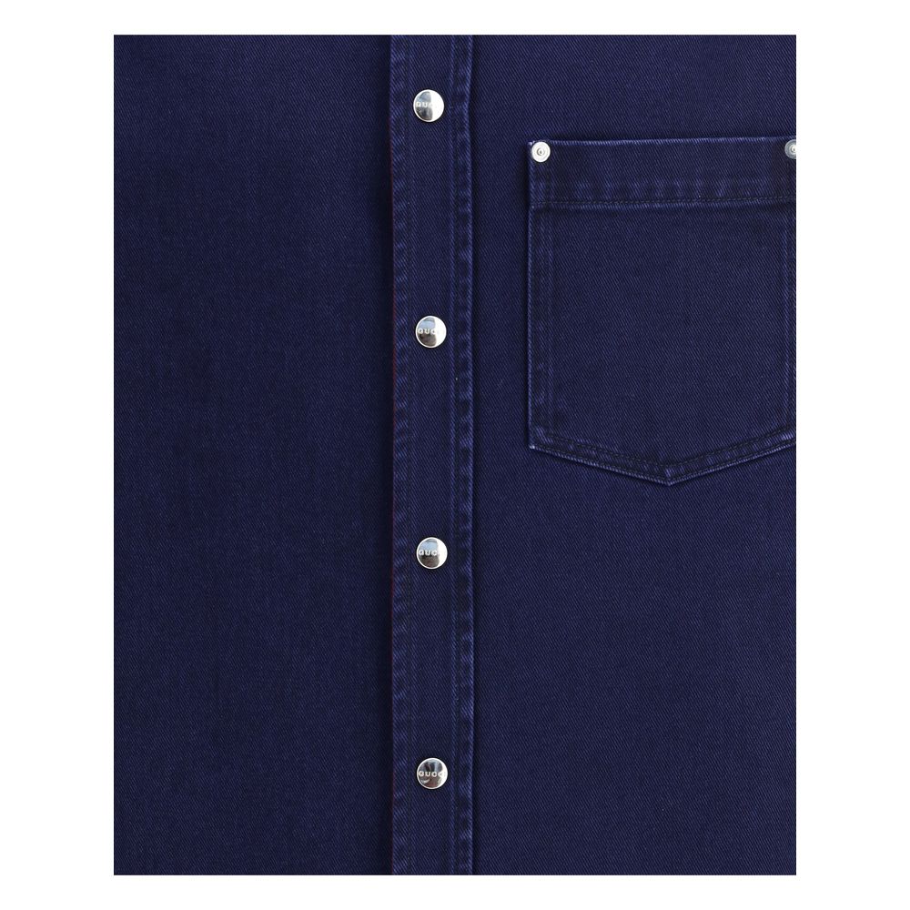 Close-up of Gucci Blue Denim Shirt showing chest pocket and Gucci metal buttons.