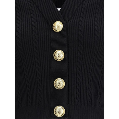Balmain Black Viscose Cardigan with ribbed design and gold embossed buttons, showcasing structured shoulders and military-inspired tabs.