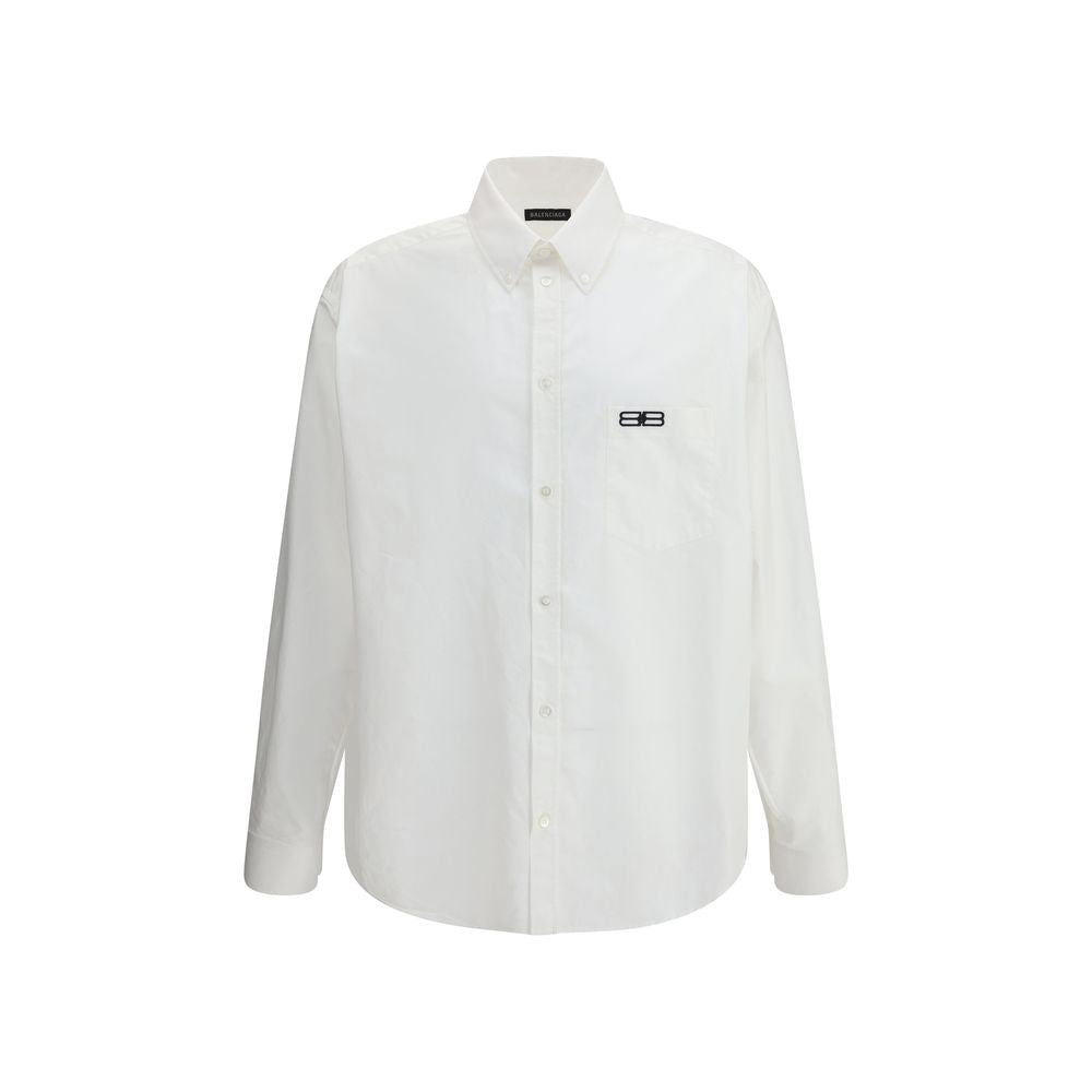 Balenciaga White Cotton Dress Shirt with classic collar and asymmetrical hem, featuring an embroidered logo and front button closure.