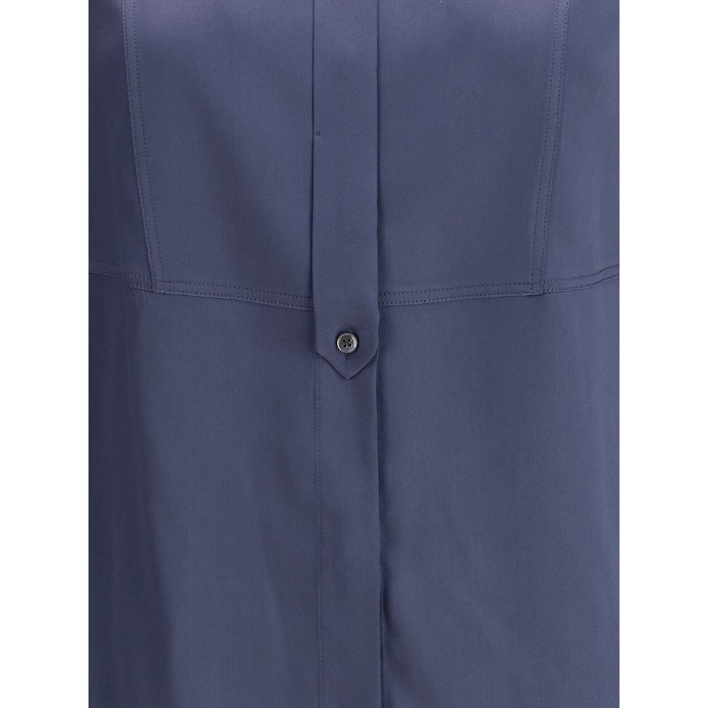 Close-up of Brunello Cucinelli Blue Silk Blouse showcasing button detail and smooth satin fabric.