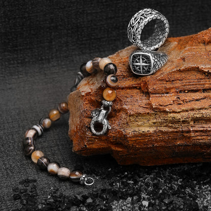 ALBERT M. JEWELS JEWELRY Mod. WSOX00396.S-28 silver ring and beaded bracelet on rustic stone, luxury accessory display.