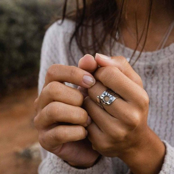 Woman wearing AN JEWELS JEWELRY Mod. AL.RFY01S-7 ring, showcasing elegant design and craftsmanship outdoors.