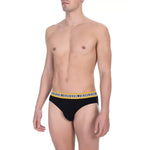 Model wearing Bikkembergs "Black Cotton Men Brief Pack" showing sleek design and comfort.