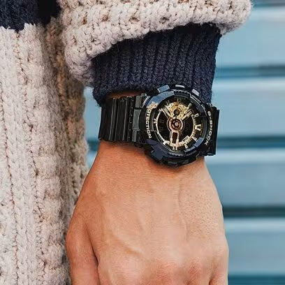 CASIO G-SHOCK Mod. GS-BASIC - BLACK ADN GOLD SERIES wristwatch with black and gold design on wrist, water resistant