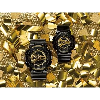 CASIO G-SHOCK Mod. GS-BASIC - BLACK ADN GOLD SERIES wristwatches with resin straps in a gold and black design against a decorative background.