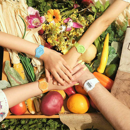 Hands wearing colorful watches join over vegetables, featuring CASIO TIMELESS COLLECTION Mod. POP - BIO RESIN STRAP - LEMON GREEN