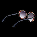 CHRISTIAN LACROIX MOD. CL5119 54227 Lady sunglasses with colorful round frames on black background