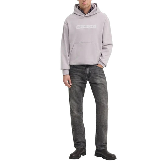 Man wearing Calvin Klein Jeans Purple Cotton Hoody with embroidered logo, paired with jeans for casual style.