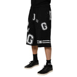 Dolce & Gabbana Black Logo Print Cotton Casual Bermuda Short, mid-waist, 100% cotton, black with white print, stylish summer wear.