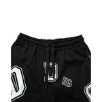 Dolce & Gabbana Black Logo Print Cotton Casual Bermuda Short with drawstring closure, featuring white logo print on black fabric.