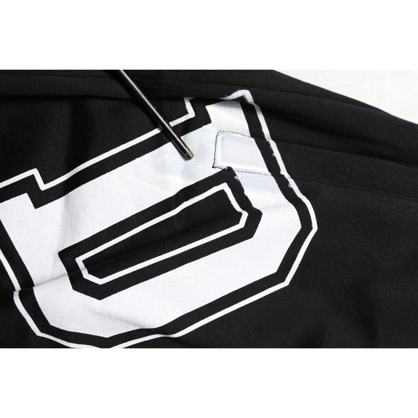 Close-up of Dolce & Gabbana Black Logo Print Cotton Casual Bermuda Short with drawstring and white logo detail.