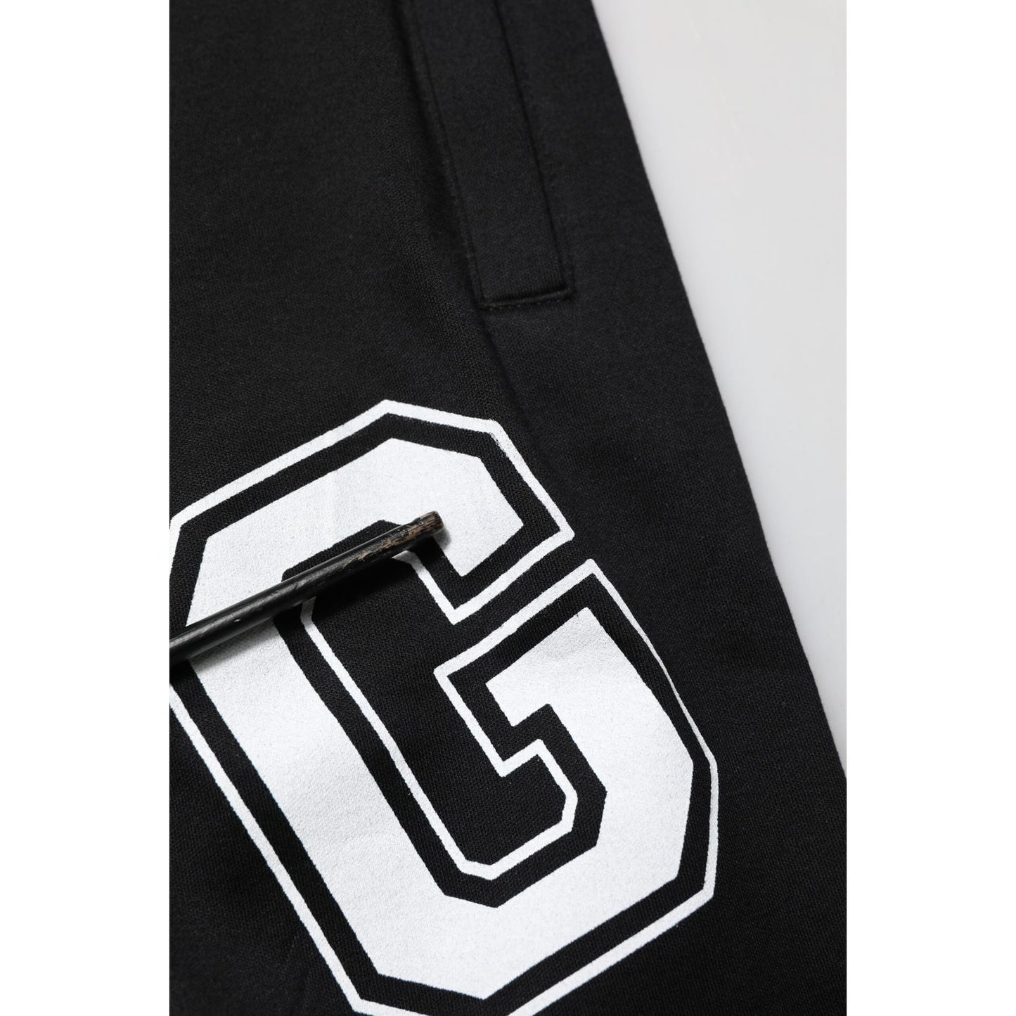 Close-up of Dolce & Gabbana Black Logo Print Cotton Casual Bermuda Short with white logo and drawstring detail.