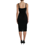 Back view of Dolce & Gabbana Black Wool Sleeveless Rose Applique Dress on mannequin, featuring elegant design for formal occasions.