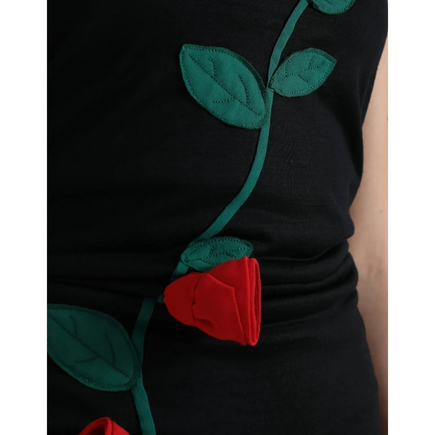 Close-up of Dolce & Gabbana Black Wool Sleeveless Rose Applique Dress showcasing red 3D rose embroidery detail.