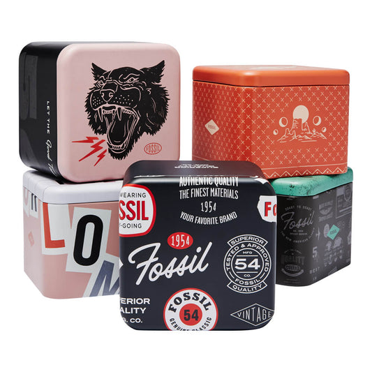 Set of colorful collectible Fossil tins with vintage designs and logos.