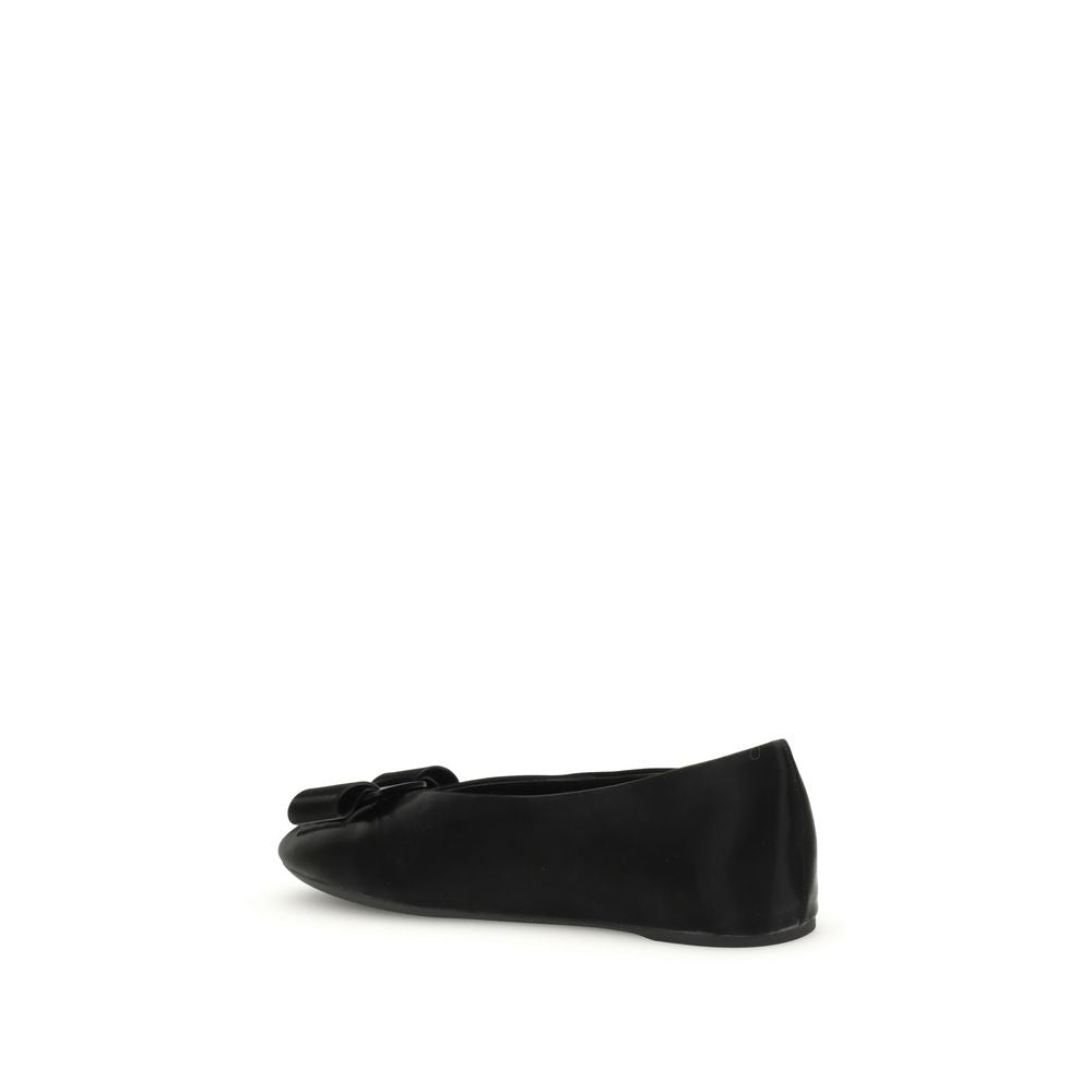 Ferragamo Black Calf Leather Bos Taurus Ballet Flats with Vara bow detail and flexible design, side view.
