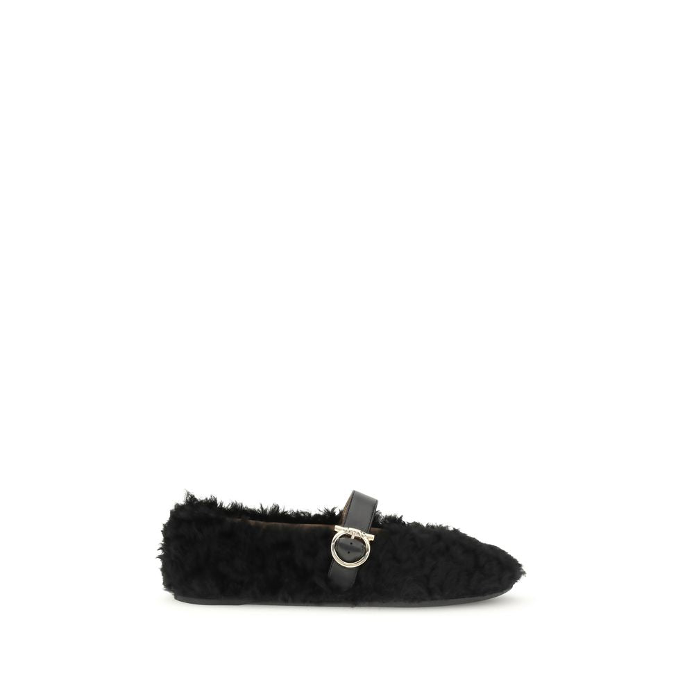 Ferragamo Black Fur Ballet Flats with Gancini buckle embellishment and shearling lining, featuring a contoured neckline and rubber sole.