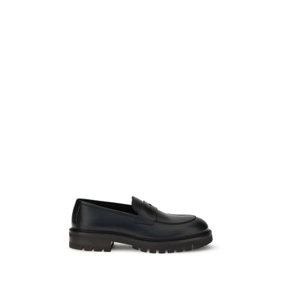 Ferragamo Black Rubber Slip-On Loafers with calfskin upper and lug tread sole for a modern twist on classic penny loafers.