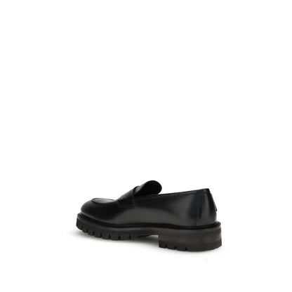 Rear view of Ferragamo Black Rubber Slip-On Loafers showing rugged sole and sleek design.