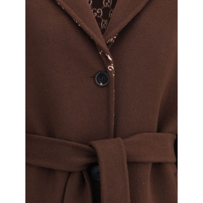 Close-up of Gucci Brown Wool Coat with GG patterned lining, featuring notch lapels and button closure.