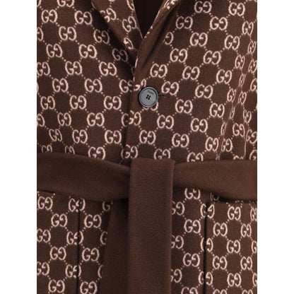 Close-up of Gucci Brown Wool Coat with GG pattern and button closure showcasing luxury fashion details.