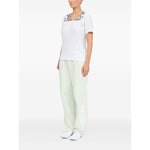 Model wearing MM6 Maison Margiela T-shirts and Polos White with V-neck and graphic print