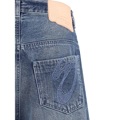 PDF Channel Blue Cotton Relaxed Fit Jeans with urban aesthetic and rubber logo patch on back pocket, AW25 fashion detail.