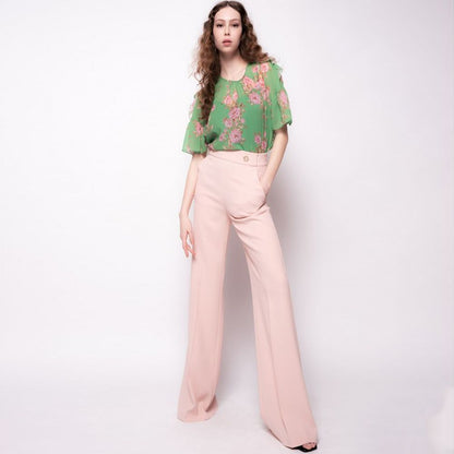 Model wearing PINKO Pink Polyester Women's Trouser, showing high waist and avant-garde leg cut in a stylish pose.