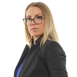 Professional woman wearing glasses and a suit looking confident