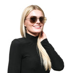 Lady wearing SWAROVSKI MOD. SK0231 5532G sunglasses with a black turtleneck, showcasing stylish eyewear for women.