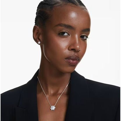 Fashion model wearing SWAROVSKI Mod. 5691486 silver 925° earrings with mineral dial. Elegant lady's jewelry with quartz analog movement.