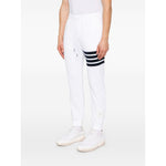Thom Browne Trousers White with drawstring waistband, side slit pockets, logo patch, and 4Bar design.