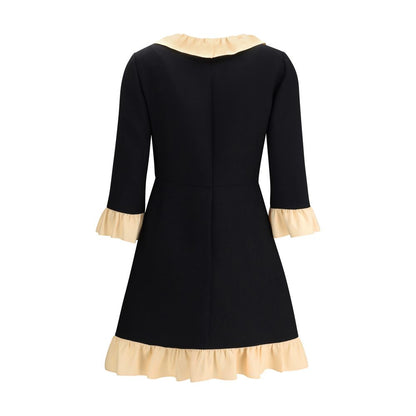 Valentino Black Fleece Wool Cocktail Dress with ruffled collar and hem, three-quarter sleeves, back view.