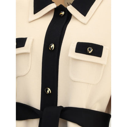 Close-up of Valentino Cream Fleece Wool Coat with black buttons and collar details, featuring decorative pockets and belt.