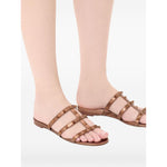 Valentino Garavani Rockstud Low Slide Sandal in Laminated Nappa Leather with brown slip-on style and signature Rockstud embellishments.